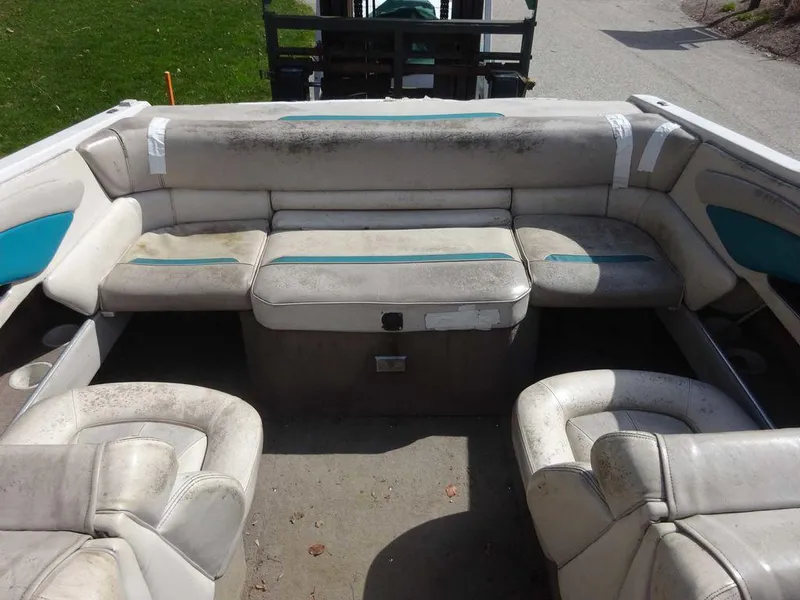 Slide: The Image of 1995 Four Winns 205 Sundowner boat interior with worn seating. - 13
