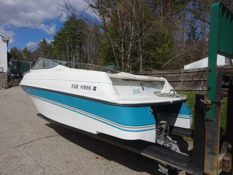 Slide: The Image of 1995 Four Winns 205 Sundowner boat on trailer, white and blue, parked outdoors. - 17