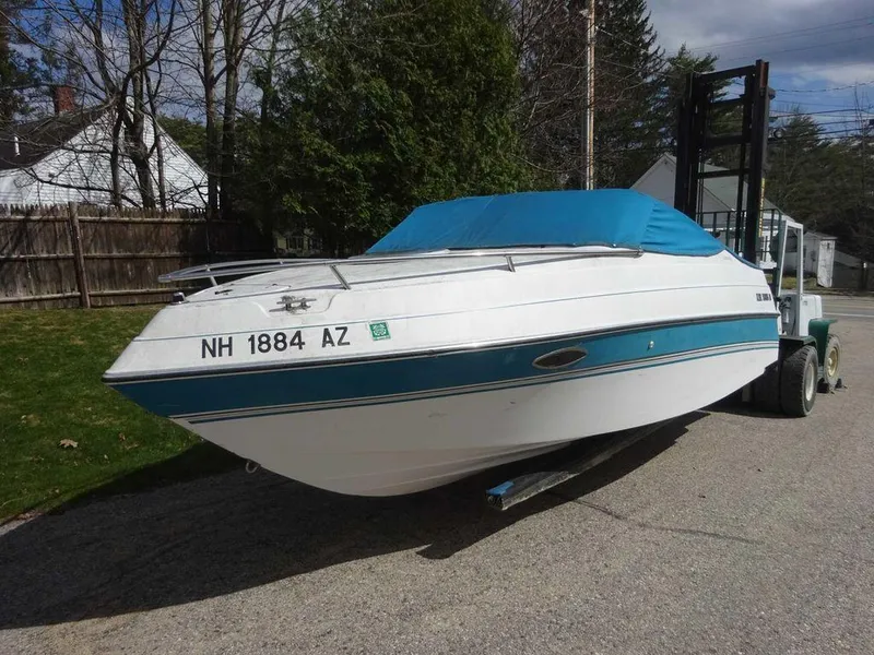 Slide: The Image of 1995 Four Winns 205 Sundowner boat with blue cover on trailer. - 19