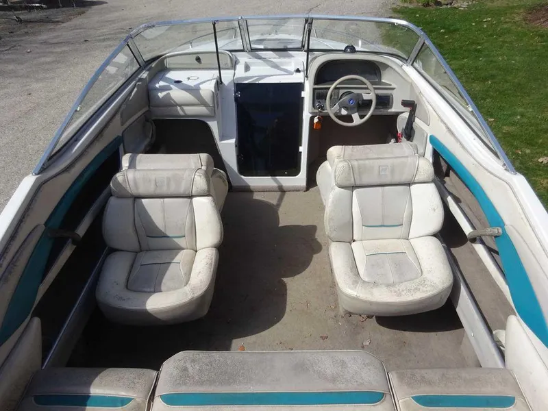 Slide: The Image of 1995 Four Winns 205 Sundowner boat interior with white and teal seating. - 2