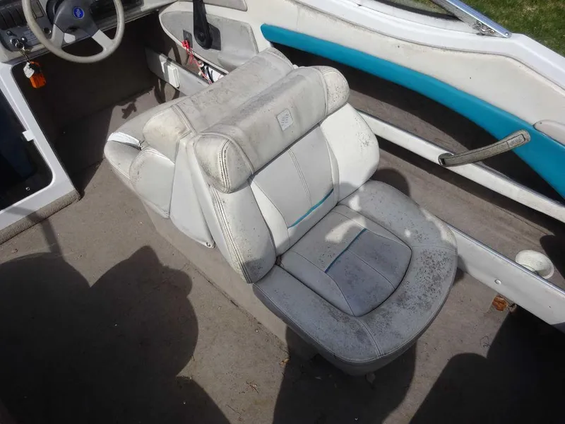 Slide: The Image of 1995 Four Winns 205 Sundowner boat interior with worn white captain's seat. - 6