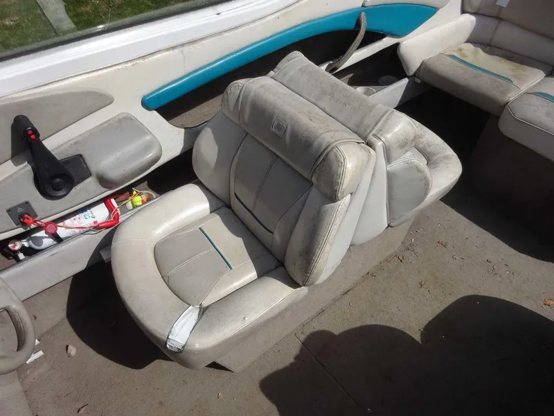 Slide: The Image of 1995 Four Winns 205 Sundowner boat interior with worn seats and storage compartments. - 9