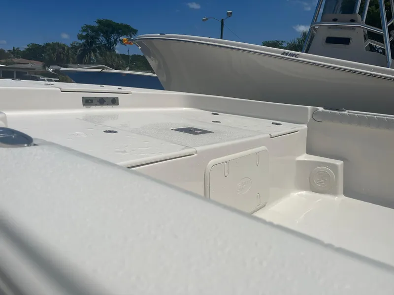 Slide: The Image of 2024 Carolina Skiff 25 LS boat deck, white finish, sunny day. - 11