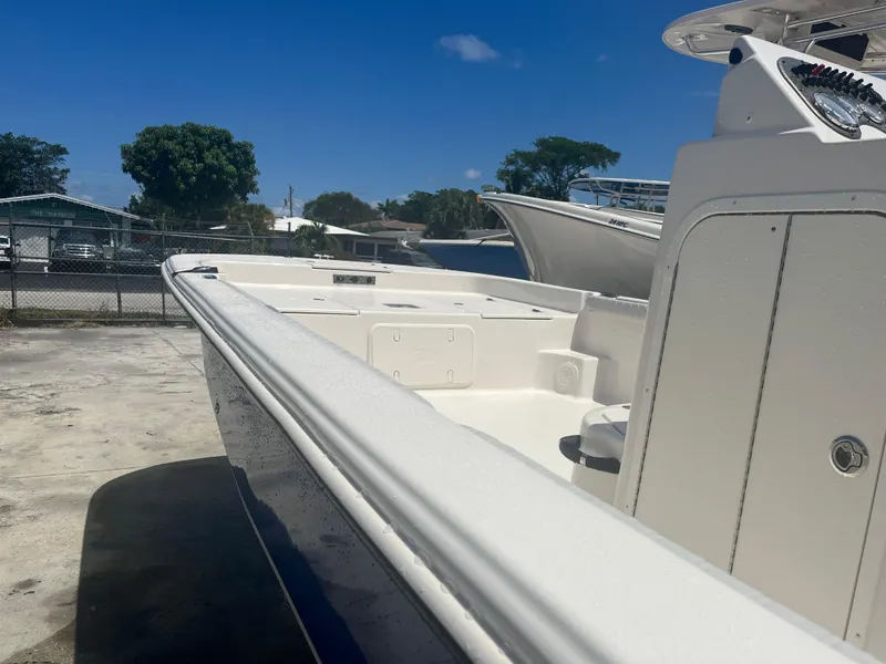 Slide: The Image of 2024 Carolina Skiff 25 LS boat docked under clear blue sky. - 6