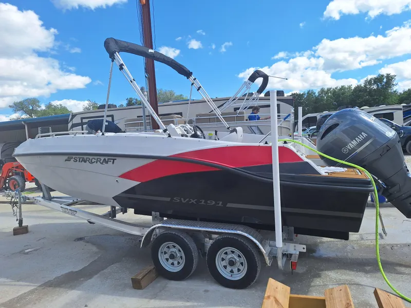 The Image of 2023 Starcraft SVX 191 OB boat on a trailer with Yamaha outboard motor. - 1