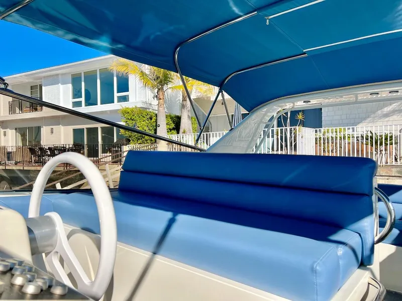 Slide: The Image of 1990 Tempest Offshore Sport Yacht with blue interior and waterfront view. - 11