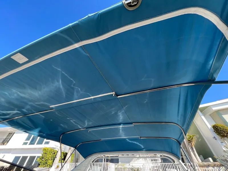 Slide: The Image of Blue canopy of a 1990 Tempest Offshore Sport Yacht against a clear sky. - 18