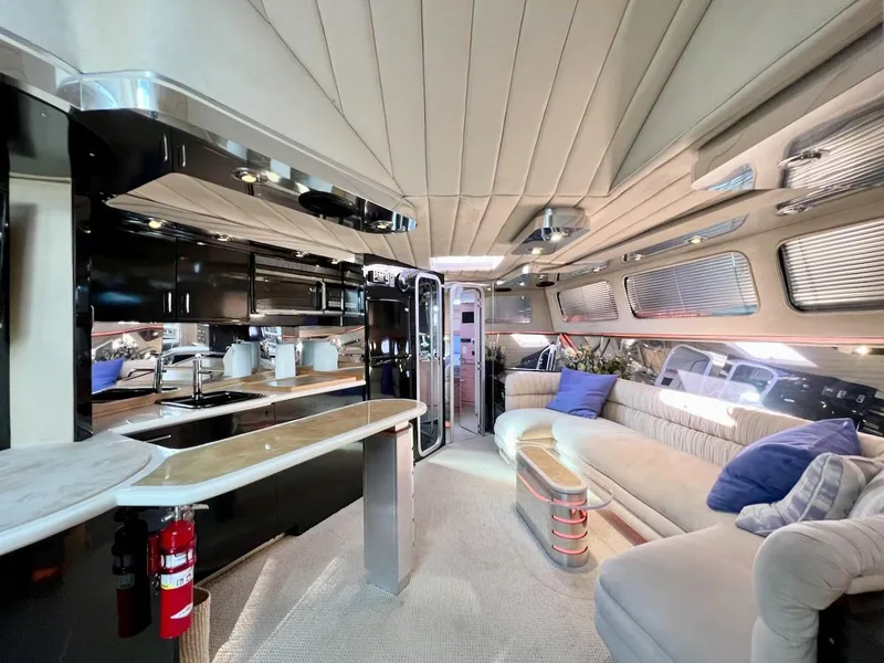 Slide: The Image of Luxurious interior of a 1990 Tempest Offshore Sport Yacht with modern kitchen and plush seating. - 19