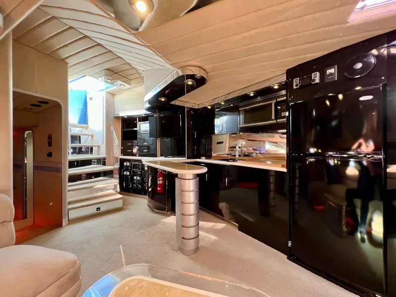 Slide: The Image of Luxurious interior of a 1990 Tempest Offshore Sport Yacht with modern kitchen and staircase. - 23