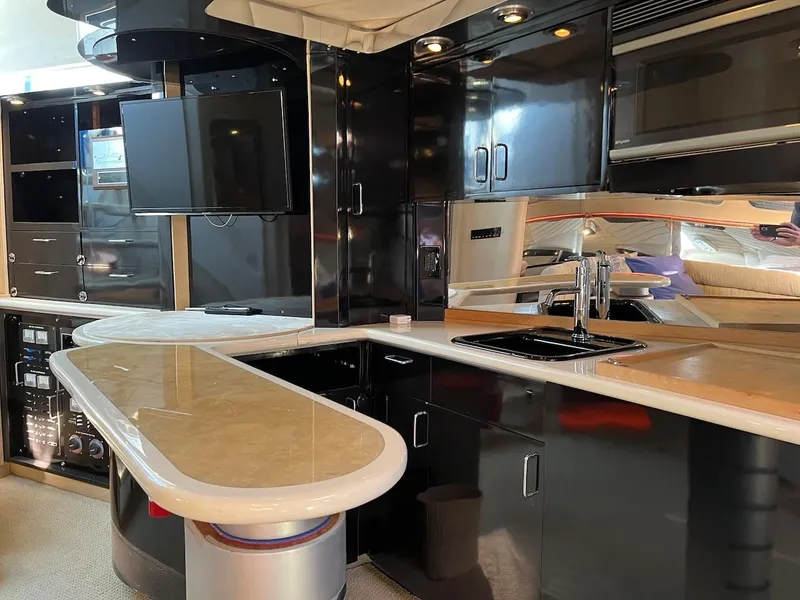 Slide: The Image of Luxurious kitchen area inside a 1990 Tempest Offshore Sport Yacht with modern amenities. - 24