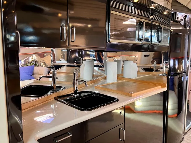 Slide: The Image of Luxurious kitchen area in a 1990 Tempest Offshore Sport Yacht with modern amenities. - 25