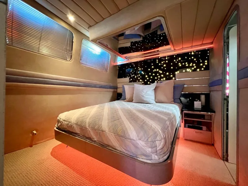 Slide: The Image of Luxurious bedroom interior of a 1990 Tempest Offshore Sport Yacht with ambient lighting. - 28
