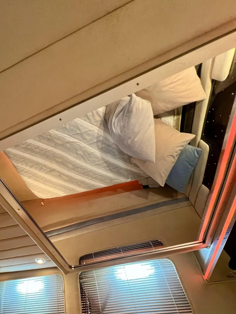 Slide: The Image of Interior cabin of a 1990 Tempest Offshore Sport Yacht with bed and pillows. - 29