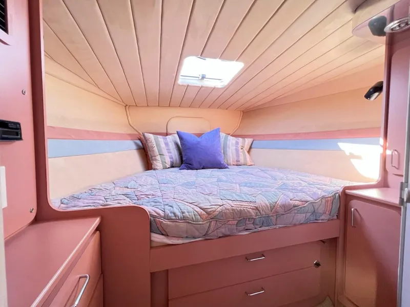 Slide: The Image of Cozy cabin interior of a 1990 Tempest Offshore Sport Yacht with a comfortable bed. - 31