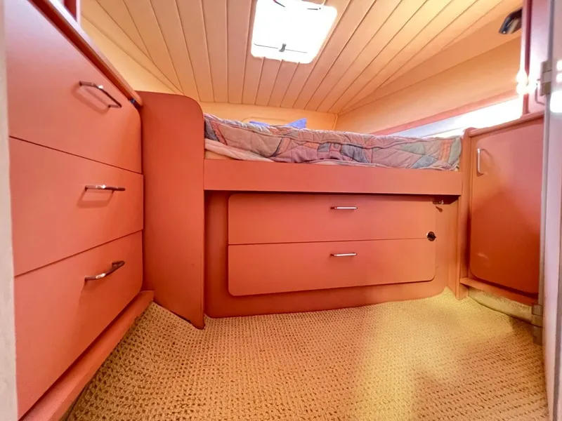 Slide: The Image of Cozy cabin interior of a 1990 Tempest Offshore Sport Yacht with built-in storage and bed. - 32