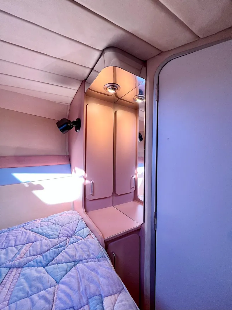 Slide: The Image of Interior cabin of a 1990 Tempest Offshore Sport Yacht with bed and storage cabinets. - 33