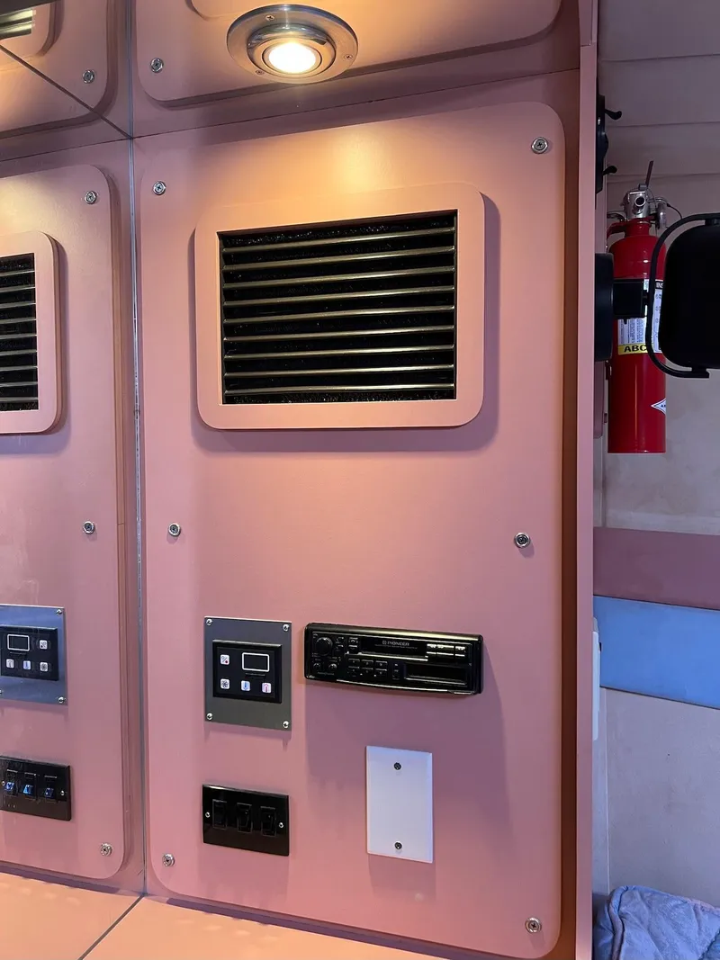 Slide: The Image of Control panel inside a 1990 Tempest Offshore Sport Yacht with ventilation and fire extinguisher. - 35