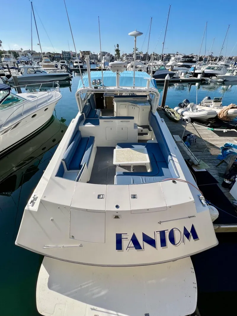 Slide: The Image of 1990 Tempest Offshore Sport Yacht Fantom docked at marina, surrounded by other boats. - 4