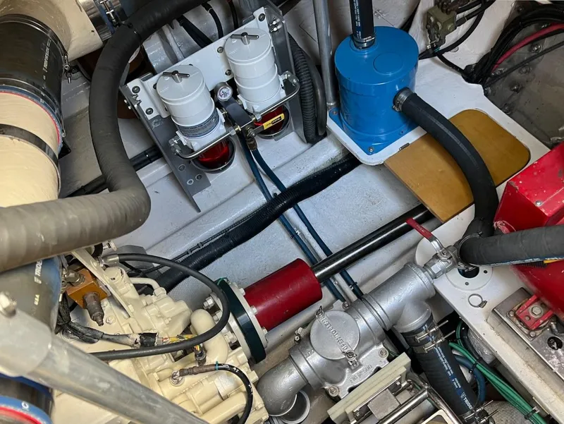 Slide: The Image of Engine room of a 1990 Tempest Offshore Sport Yacht showing various mechanical components. - 40