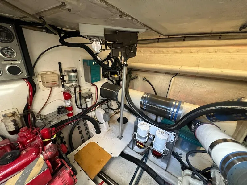 Slide: The Image of Engine room of a 1990 Tempest Offshore Sport Yacht with various mechanical components. - 43