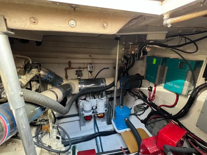 Slide: The Image of Engine room of a 1990 Tempest Offshore Sport Yacht with various mechanical components. - 44