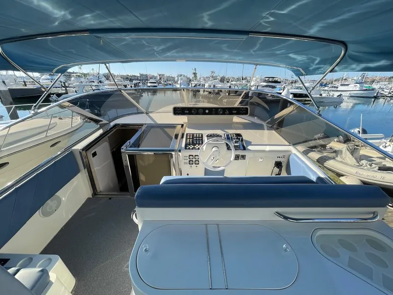 Slide: The Image of 1990 Tempest Offshore Sport Yacht cockpit with modern controls and marina view. - 5