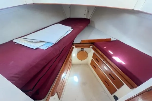 Slide: The Image of 1972 Grand Banks Trawler cabin with twin beds and wooden storage drawers. - 2