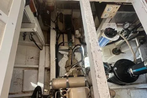 Slide: The Image of Engine room of a 1972 Grand Banks Trawler, showcasing mechanical components and piping. - 9