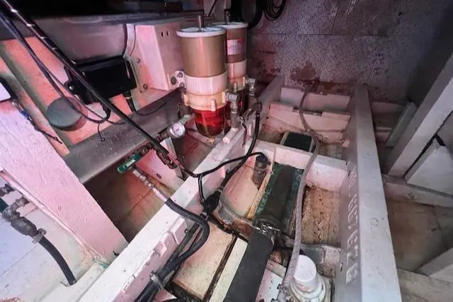 Slide: The Image of Engine room of a 1972 Grand Banks Trawler, showcasing mechanical components and wiring. - 11