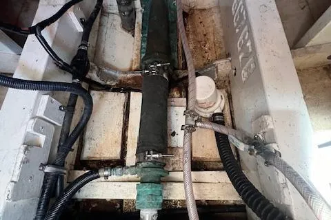 Slide: The Image of Engine compartment of a 1972 Grand Banks Trawler, showing hoses and mechanical components. - 12