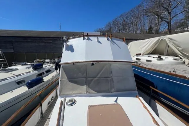 Slide: The Image of 1972 Grand Banks Trawler docked, surrounded by other boats under clear blue sky. - 15