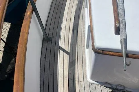 Slide: The Image of 1972 Grand Banks Trawler deck with wooden railings and classic design elements. - 16