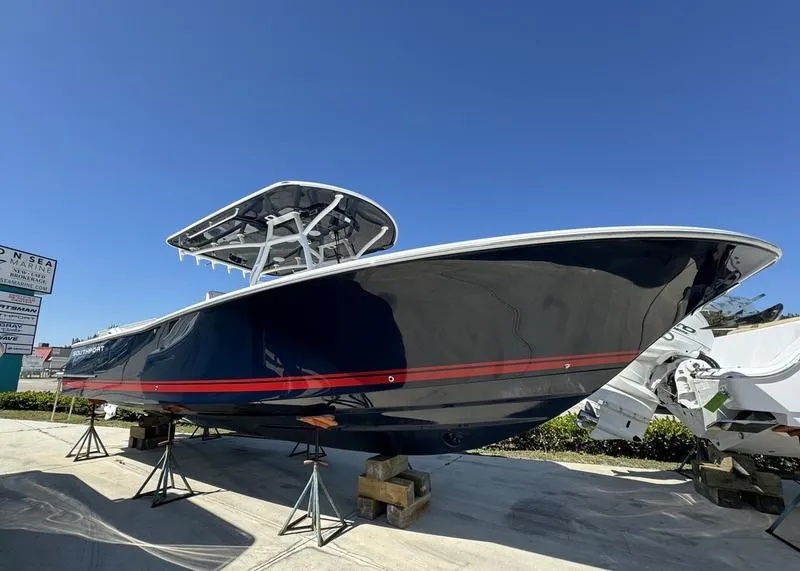 Slide: The Image of 2024 Southport 30 FE boat on stands under clear blue sky. - 1