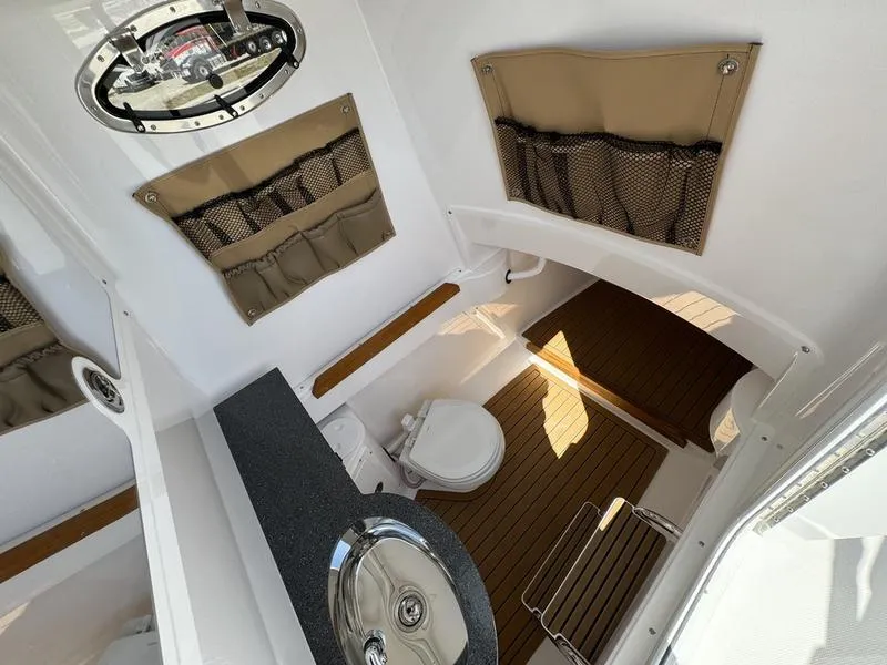 Slide: The Image of 2024 Southport 30 FE boat interior with toilet and sink. - 15