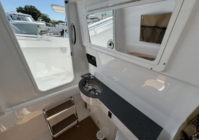 Slide: The Image of 2024 Southport 30 FE boat interior with sink and mirror. - 17