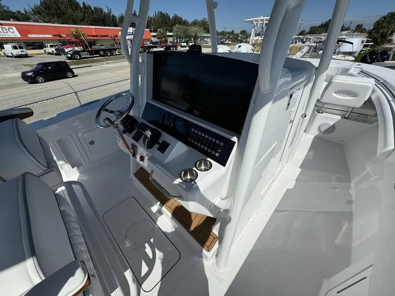 Slide: The Image of 2024 Southport 30 FE boat cockpit with modern controls and seating. - 19