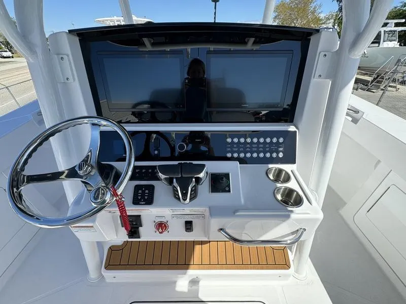 Slide: The Image of 2024 Southport 30 FE boat helm with dual screens and modern controls. - 20