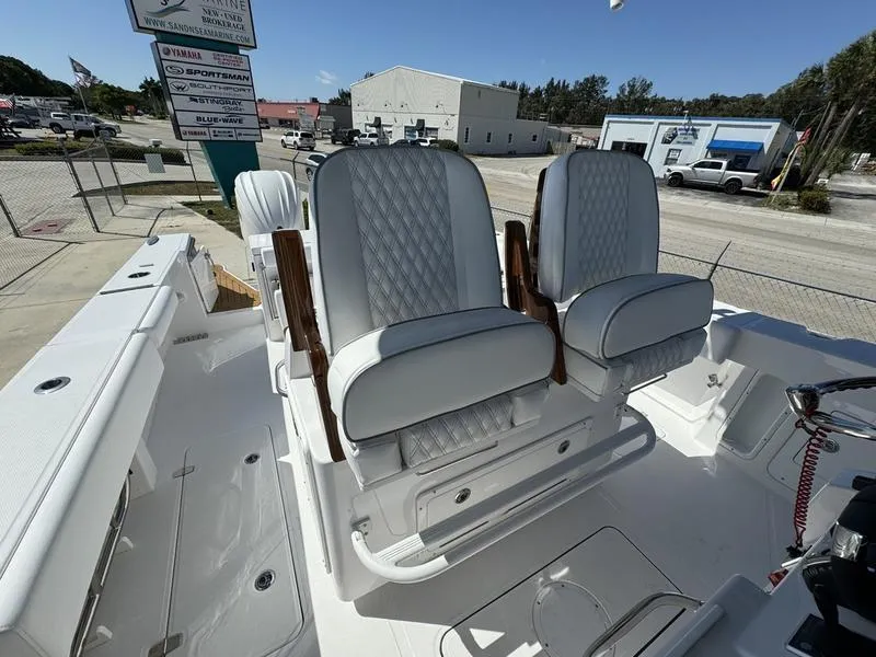 Slide: The Image of 2024 Southport 30 FE boat with luxurious white seating and wooden armrests. - 24