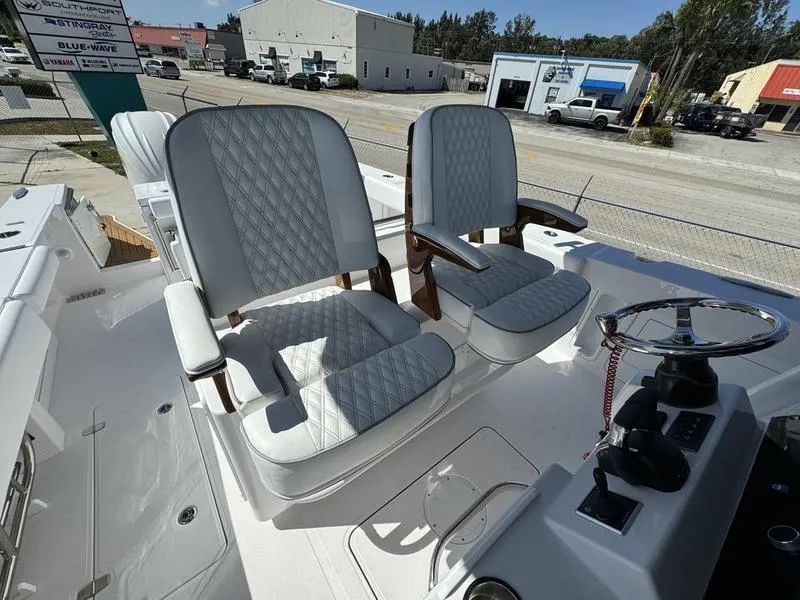 Slide: The Image of 2024 Southport 30 FE boat with luxurious seating and modern controls. - 26