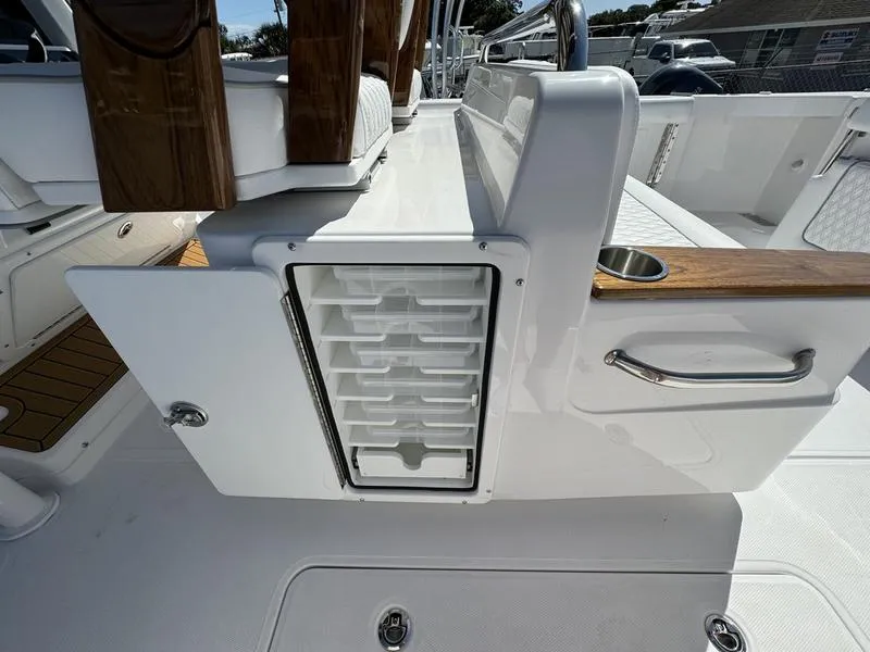 Slide: The Image of 2024 Southport 30 FE boat interior with storage compartment and seating. - 28
