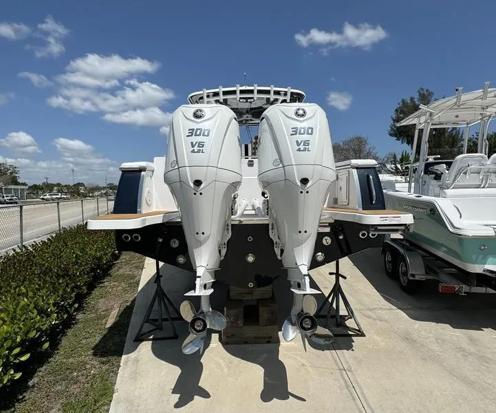 Slide: The Image of 2024 Southport 30 FE boat with twin 300 V6 engines, docked on a sunny day. - 3