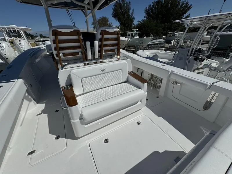 Slide: The Image of 2024 Southport 30 FE boat interior with white seating and wooden accents. - 30
