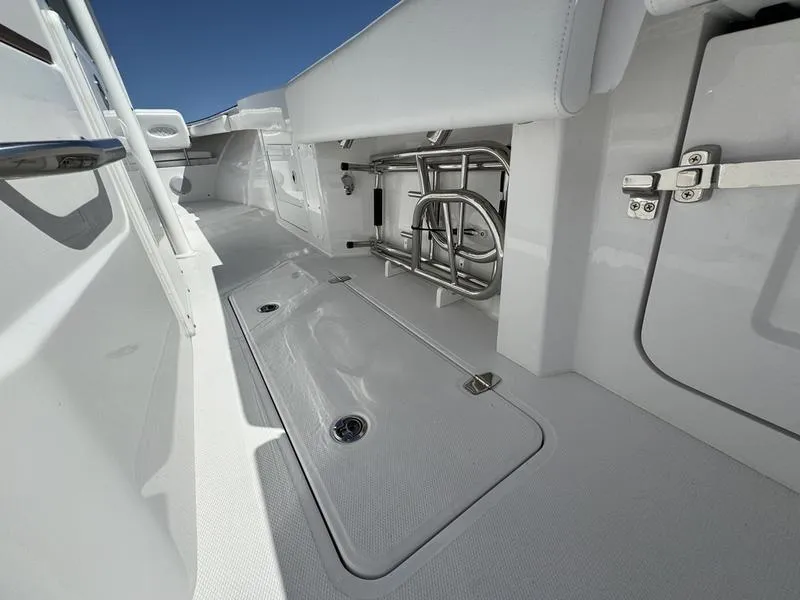 Slide: The Image of 2024 Southport 30 FE boat interior with storage compartments and stainless steel fixtures. - 32