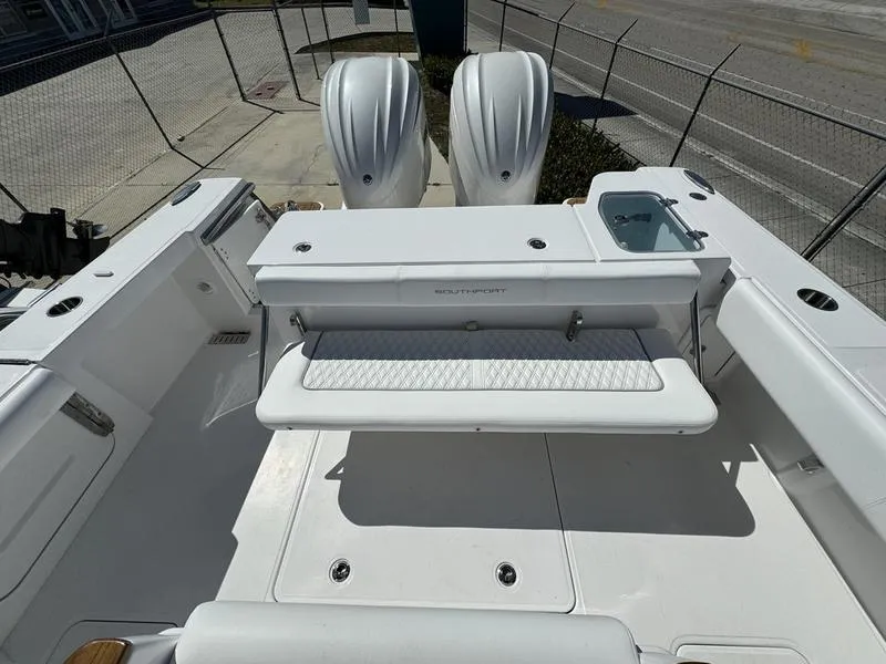 Slide: The Image of 2024 Southport 30 FE boat with dual outboard engines and seating area. - 33