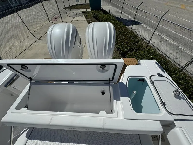 Slide: The Image of 2024 Southport 30 FE boat with open storage compartments and twin engines. - 34