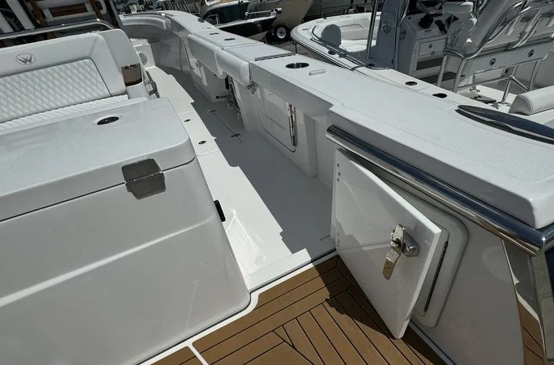 Slide: The Image of 2024 Southport 30 FE boat deck with storage compartments and seating. - 35