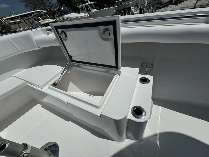 Slide: The Image of 2024 Southport 30 FE boat with open storage compartment and cup holders. - 7