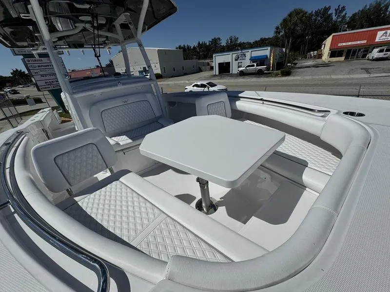 Slide: The Image of 2024 Southport 30 FE boat with white cushioned seating and table. - 8