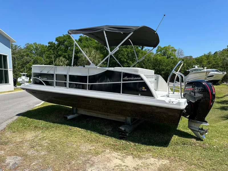 Slide: The Image of 2024 Hurricane FunDeck 2260 RE OB pontoon boat with canopy on display. - 1
