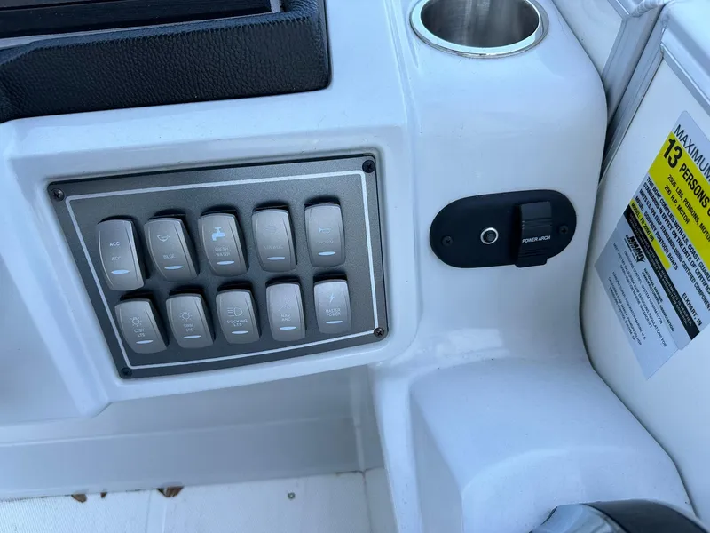 Slide: The Image of Control panel of 2024 Hurricane FunDeck 2260 RE OB boat with switches and cup holder. - 11